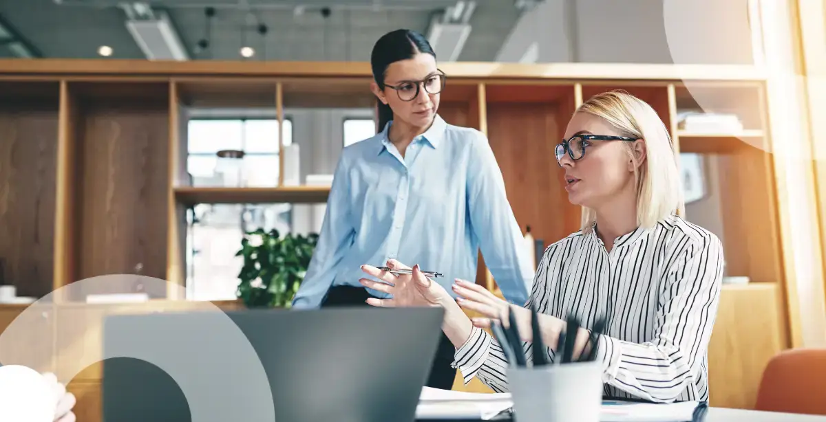 Two business women in an office setting discuss security