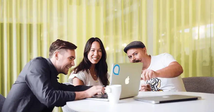 three employees at Telavox discussing the desktop app